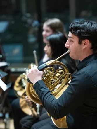 Student playing french horn