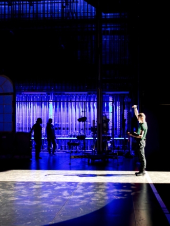 A technician stands on stage at the Cantor Theatre.