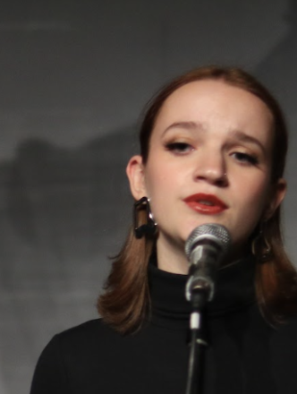 Girl on stage at microphone singing