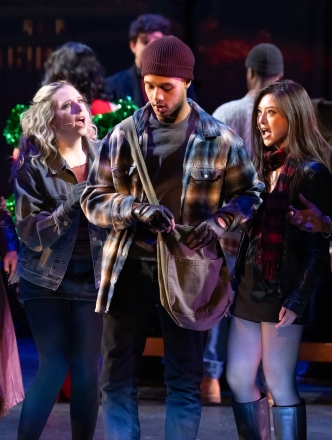 Four angry performers gathered around one who is dealing drugs