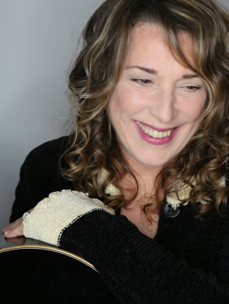 Singer and Songwriter Beth Neilsen Chapman headshot smiling and looking down