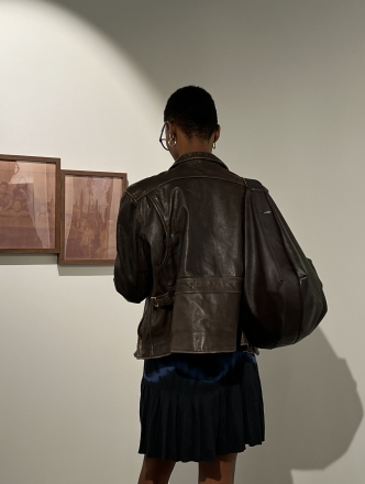 A student looks at artwork in NYU's Latinx Gallery at 20 Cooper Union.