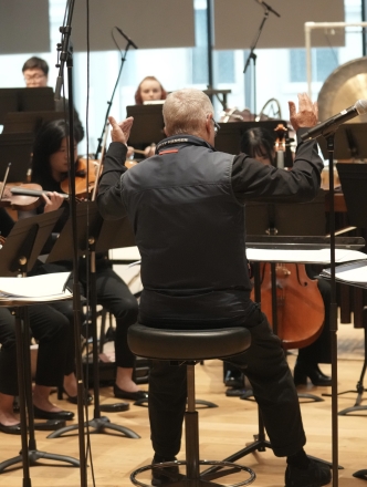 Chamber group practicing and being led by conductor