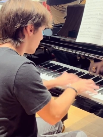 Student at the keyboard of grand piano