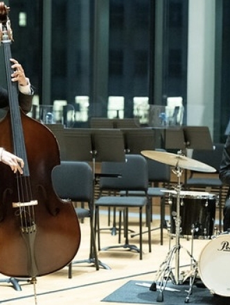 Jazz performers: piano, bass and drummer