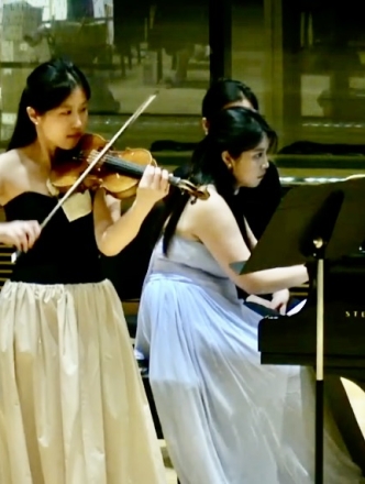 Violinist and pianist performing together in Paulson Center