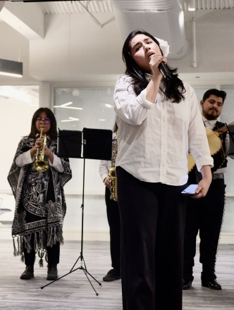 Mariachi instrumental performers and one singer in the center